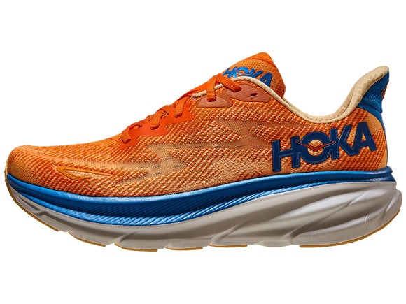 HOKA Clifton 9 running shoe. Upper is vibrant orange with a white HOKA logo in the heel. The midsole has a top layer of blue road and a bottom layer of white foam. 