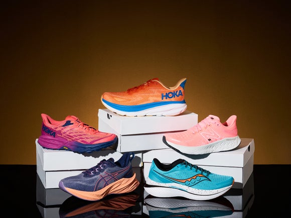 Five running shoes stacked on top of boxes